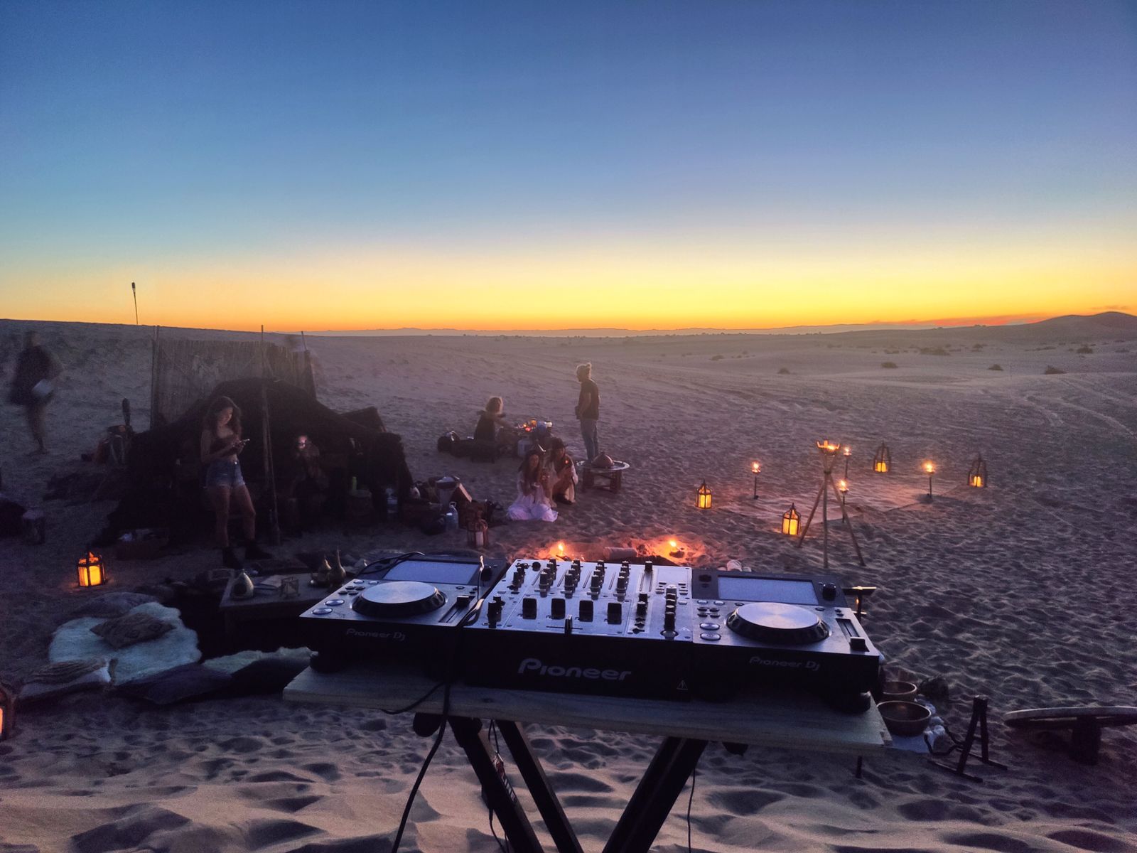 DJ controller on the sand at sunset